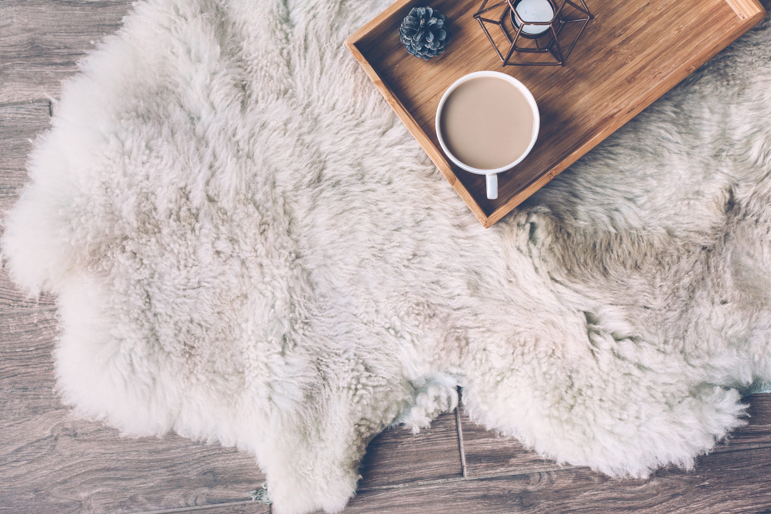 fur rug on laminate floor with coffee table on top