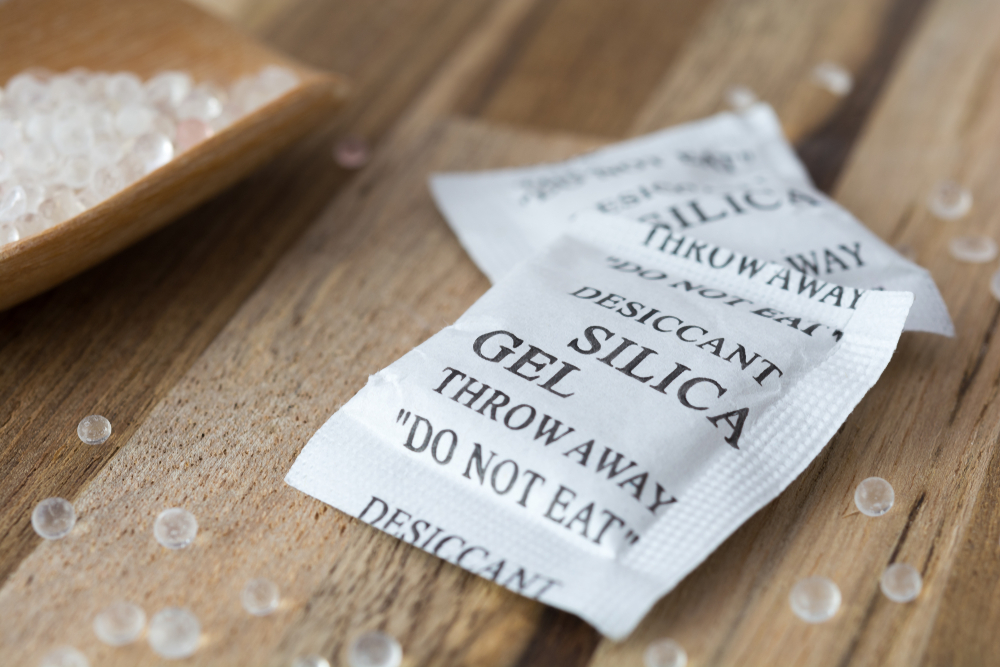 Silica gel packets on a wooden table