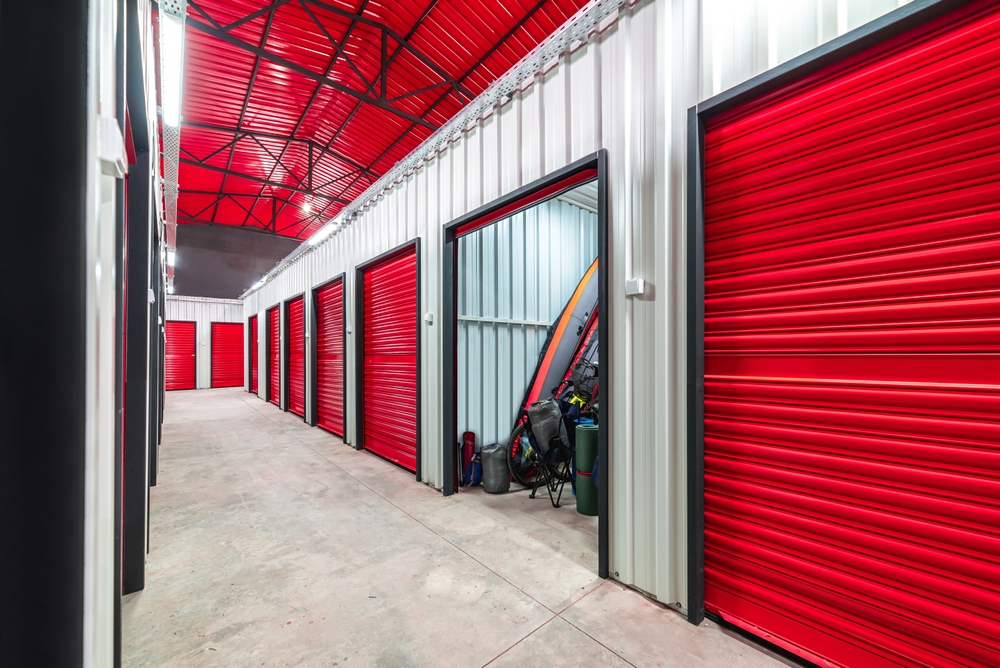 Corridor of indoor storage units with red doors
