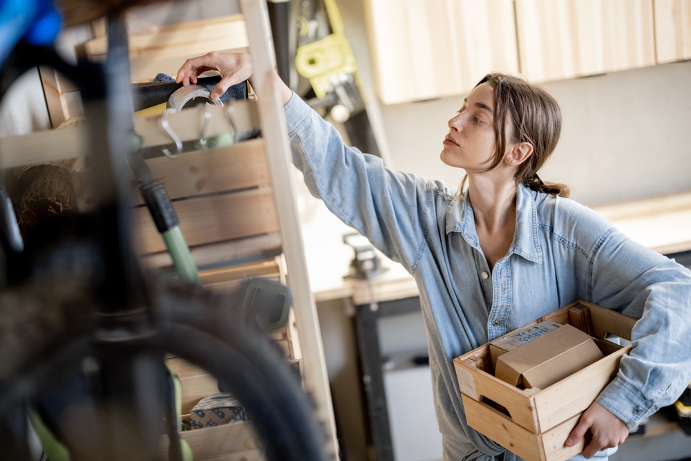 Woman organizing garage and looking into boxes