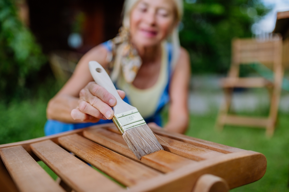 Woman sealing a wooden chair