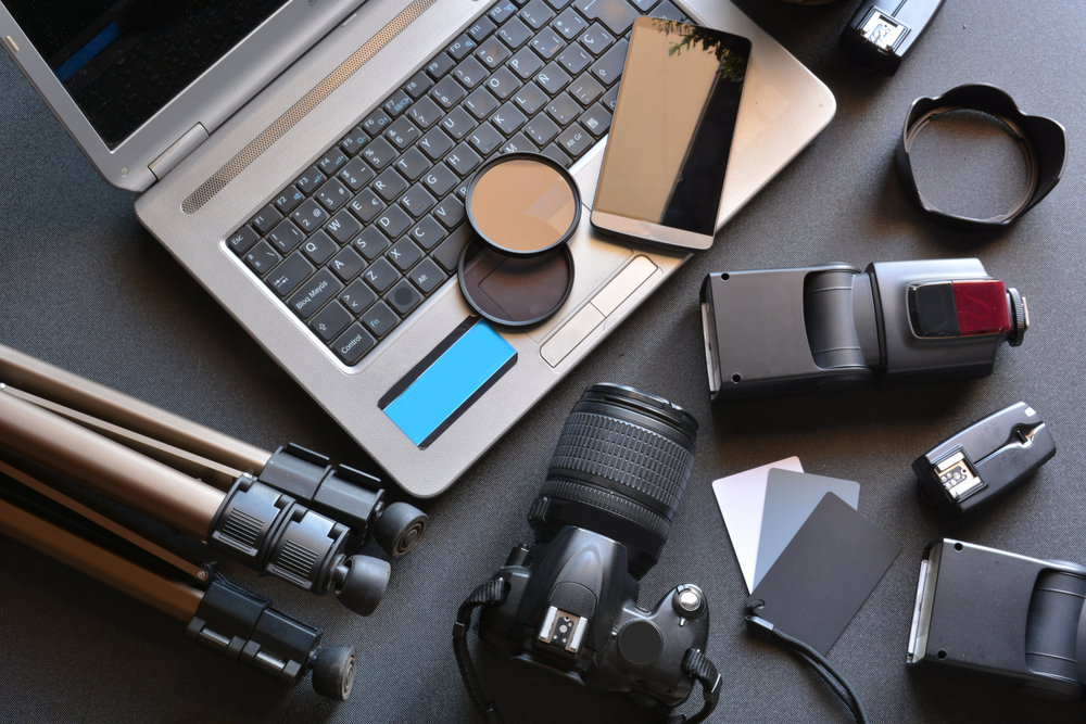 Desktop with various pieces of camera equipment laid out